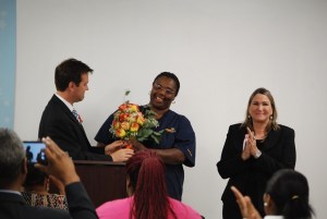 LaTasha Clark, a student at Medtech College, is presented with a dozen roses for Mothers' Day. Photo by Lauren Ramsdell.
